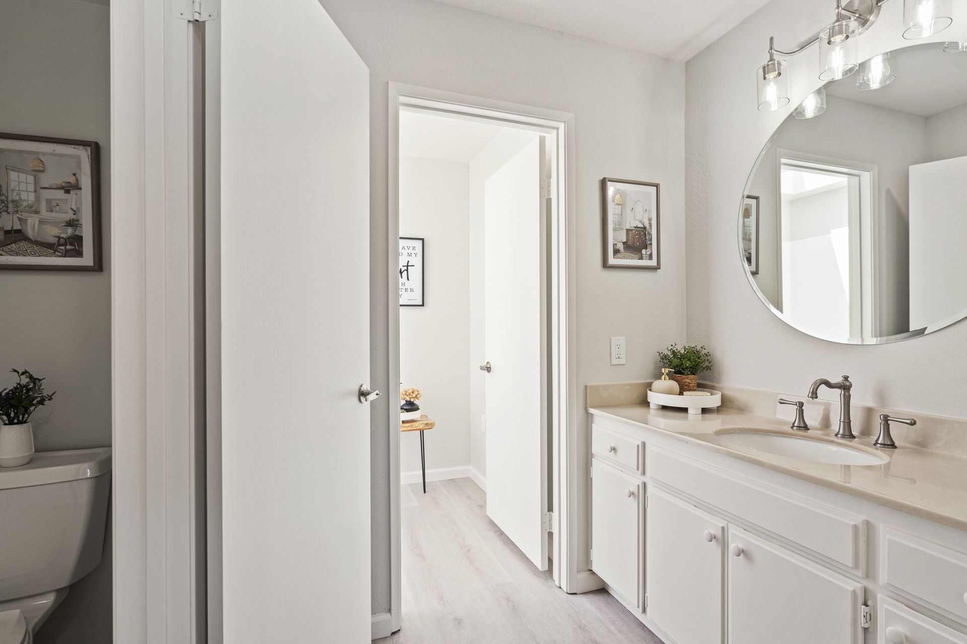 A bathroom with a sink , toilet and mirror.