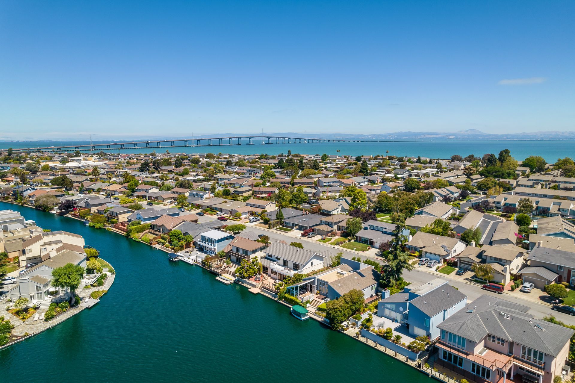 An aerial view of a residential area next to a body of water.