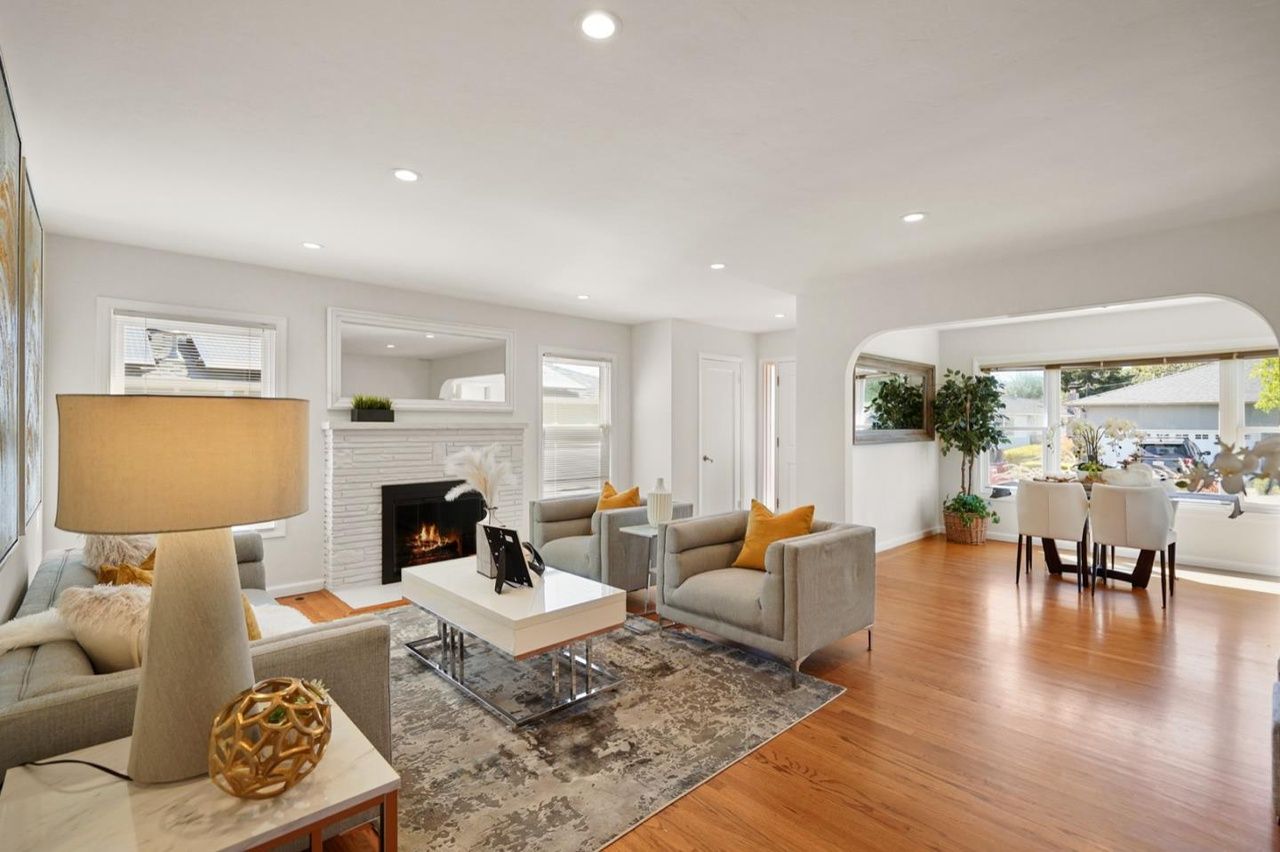 A living room filled with furniture and a fireplace.
