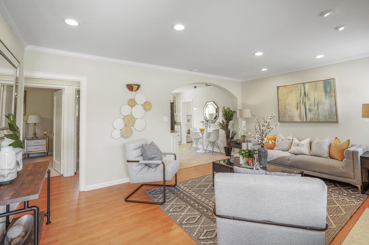 A living room filled with furniture and a rug.