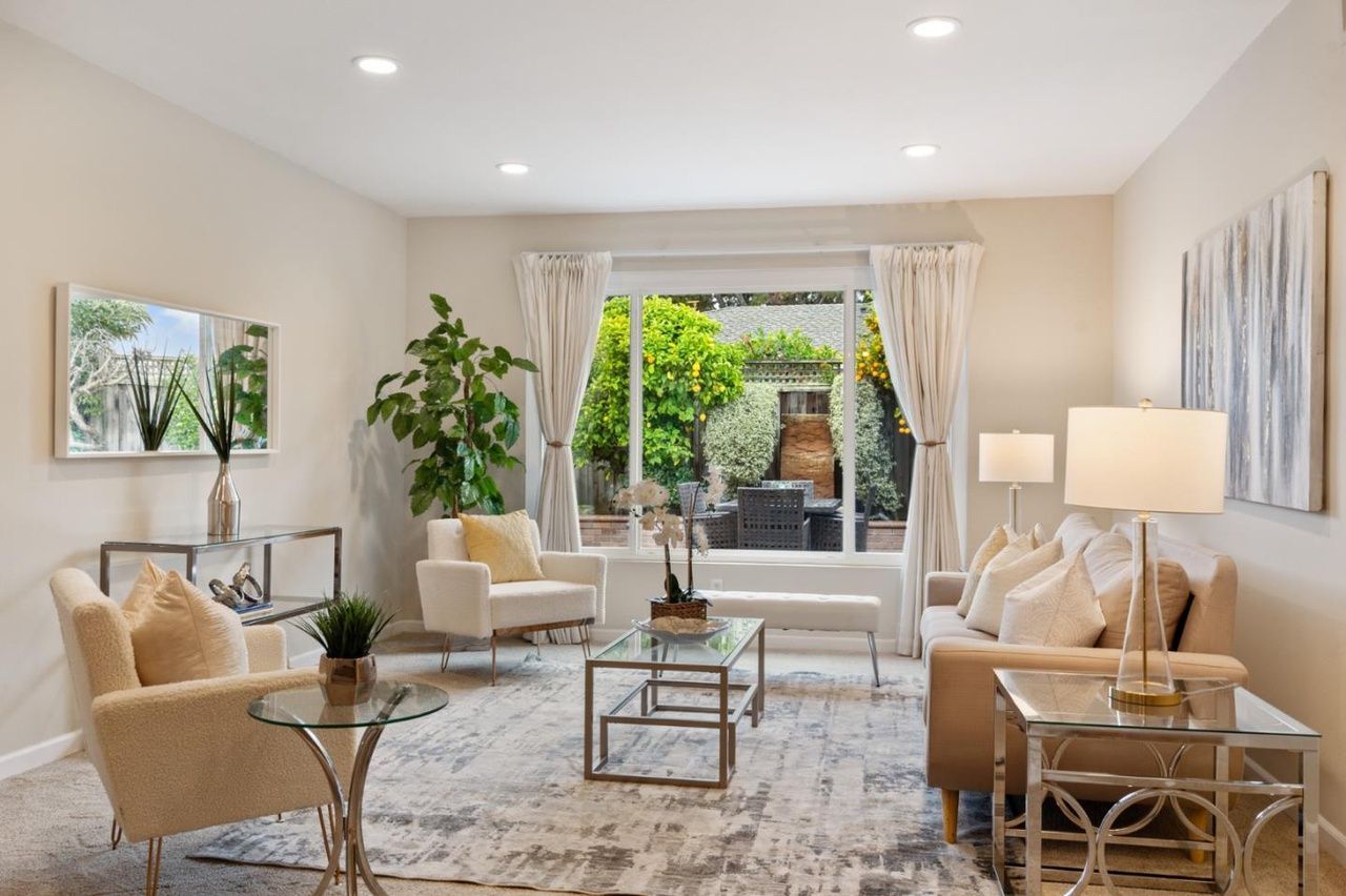 A living room filled with furniture and a large window.