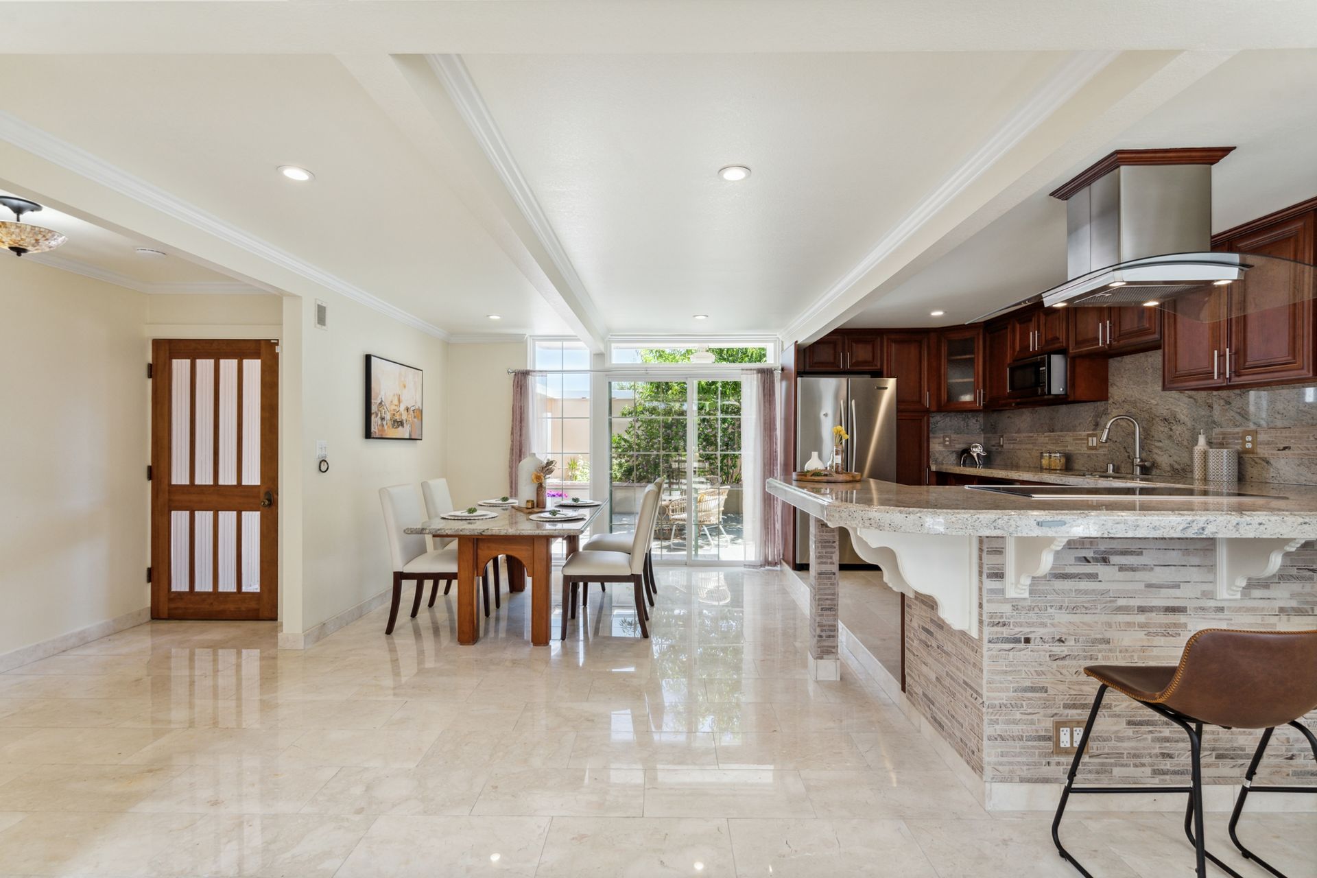 A kitchen with a table and chairs in it