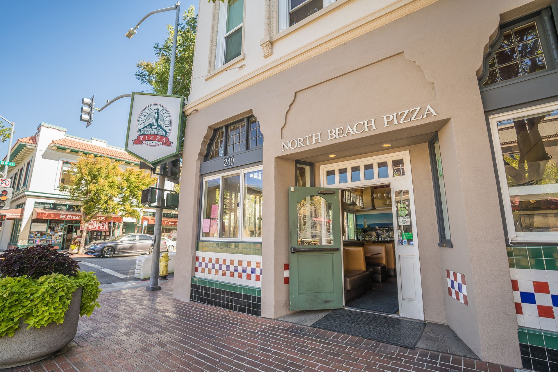 A building with a sign that says ' capitol pizza ' on it