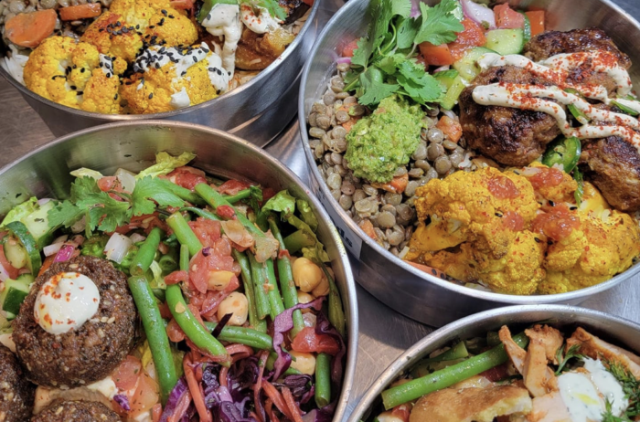 A close up of four bowls of food on a table.