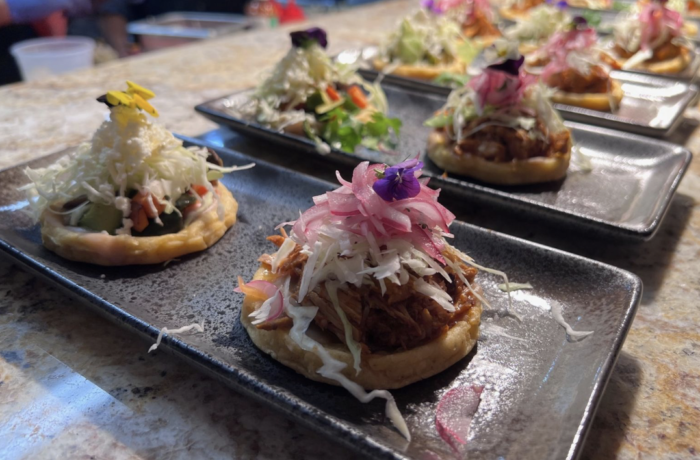 A row of plates filled with food on a table.