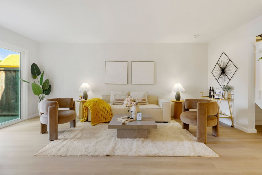 Open-concept living and dining area with vinyl plank floors, large sliders, and brick fireplace, listed by Foster City Realtor Rumana Jabeen.