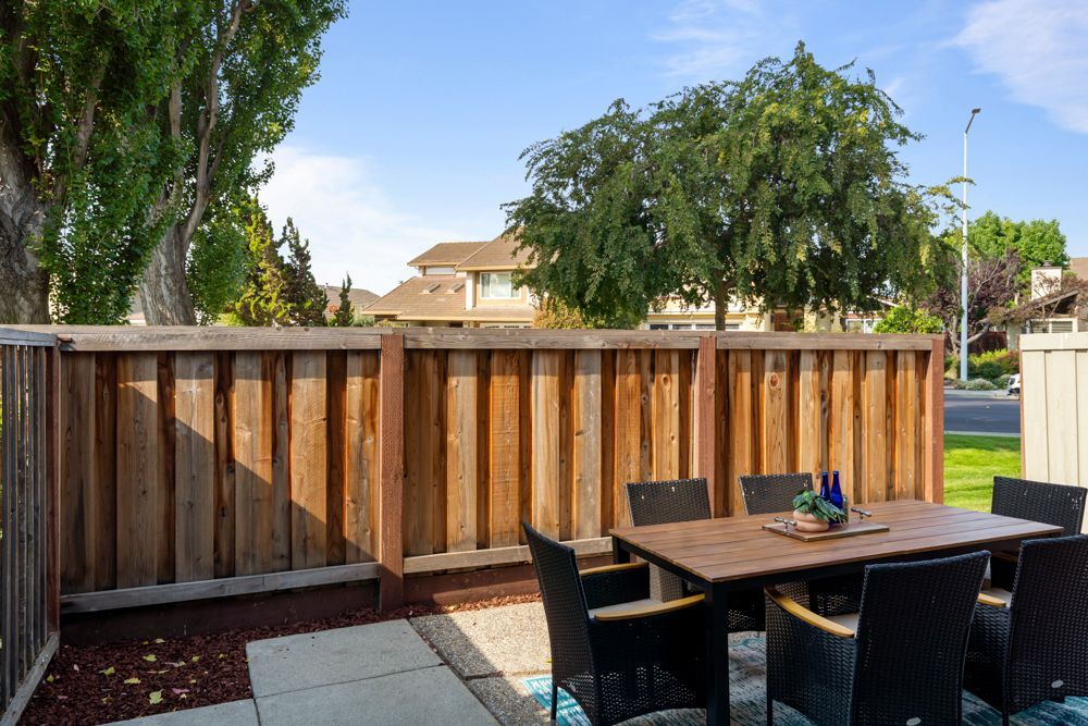 Versatile rear patio with space for outdoor dining or container gardening, represented by Rumana Jabeen Real Estate.