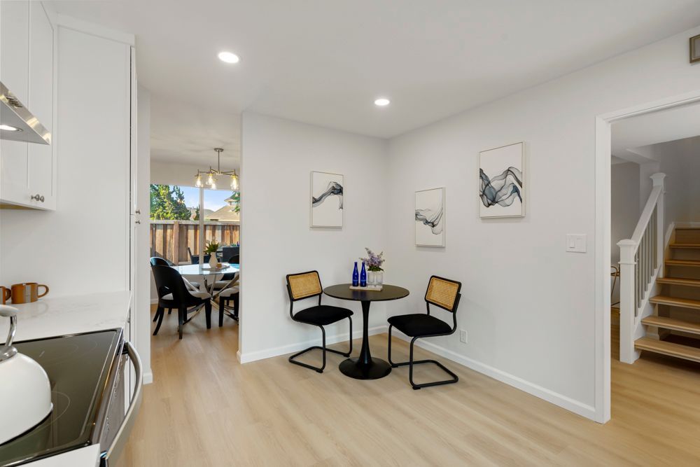 Eat-in kitchen nook with window views of the front patio, ideal for casual meals, presented by Rumana Jabeen Real Estate.