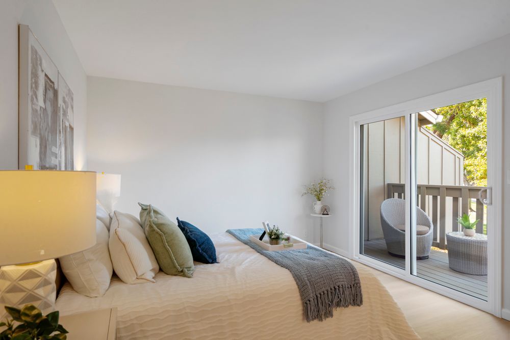Spacious primary bedroom with private balcony and hillside views, located in Foster City’s Harborside community, listed by Rumana Jabeen Realtor.