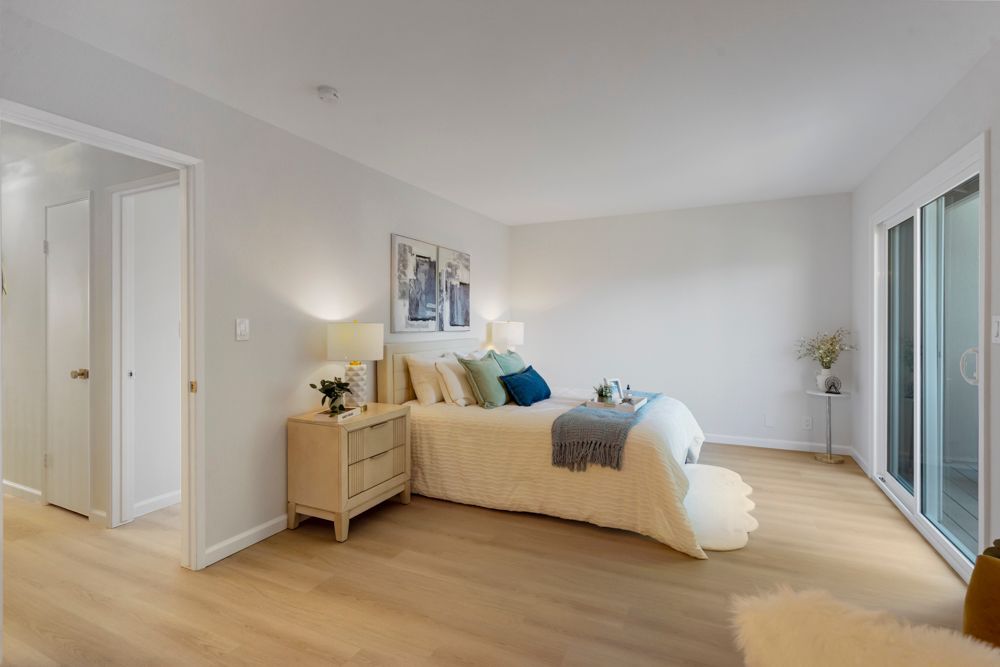 Spacious primary bedroom with private balcony and hillside views, located in Foster City’s Harborside community, listed by Rumana Jabeen Realtor.
