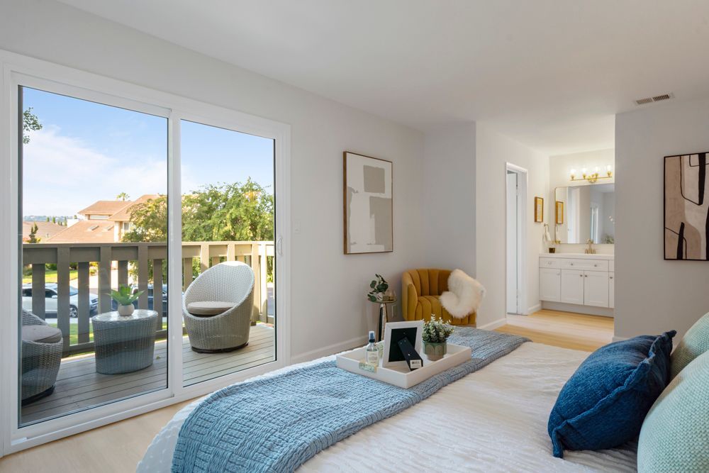 Spacious primary bedroom with private balcony and hillside views, located in Foster City’s Harborside community, listed by Rumana Jabeen Realtor.