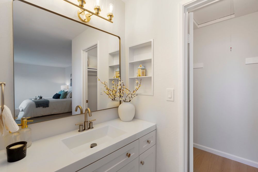 Updated primary bathroom with quartz vanity, glass shower, and walk-in closet, listed with Foster City Realtor Rumana Jabeen.