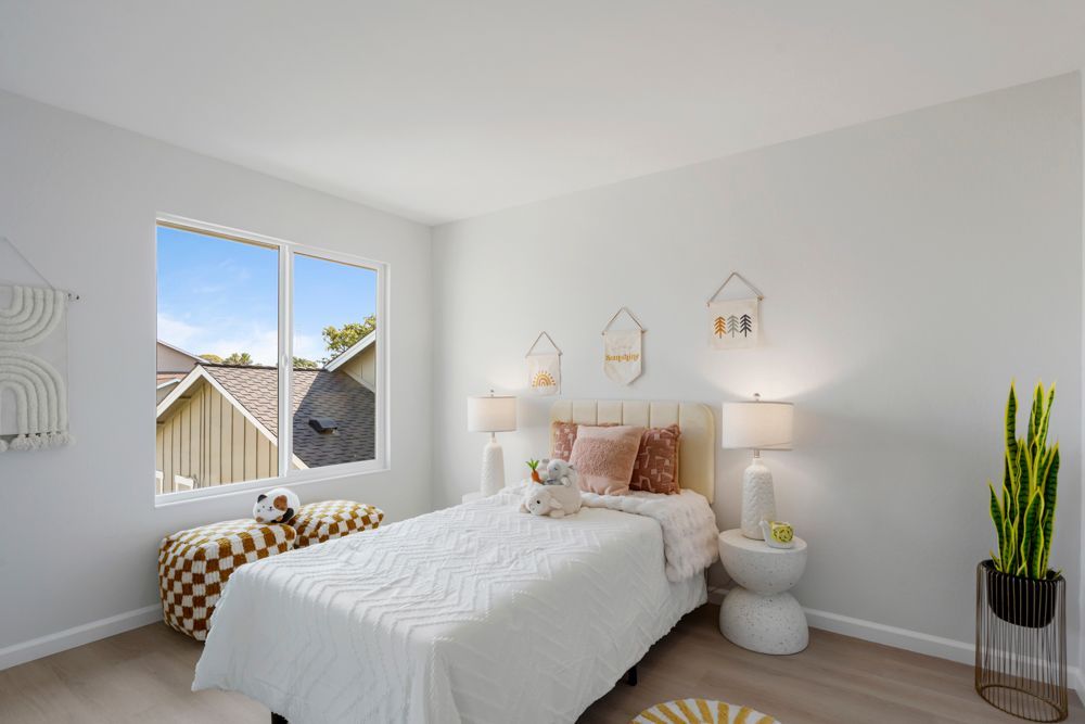 Secondary bedroom with mirrored closet and leafy outlooks, located in Foster City’s desirable Harborside townhome community, listed with Rumana Jabeen Realtor.