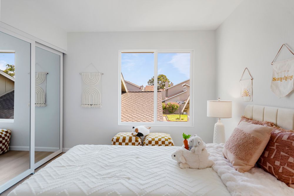 Secondary bedroom with mirrored closet and leafy outlooks, located in Foster City’s desirable Harborside townhome community, listed with Rumana Jabeen Realtor.