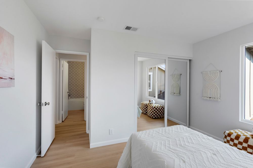 Secondary bedroom with mirrored closet and leafy outlooks, located in Foster City’s desirable Harborside townhome community, listed with Rumana Jabeen Realtor.