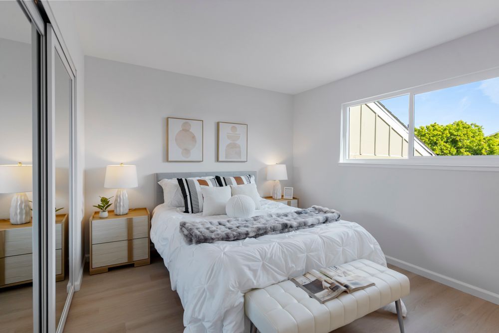 Secondary bedroom with mirrored closet and leafy outlooks, located in Foster City’s desirable Harborside townhome community, listed with Rumana Jabeen Realtor.