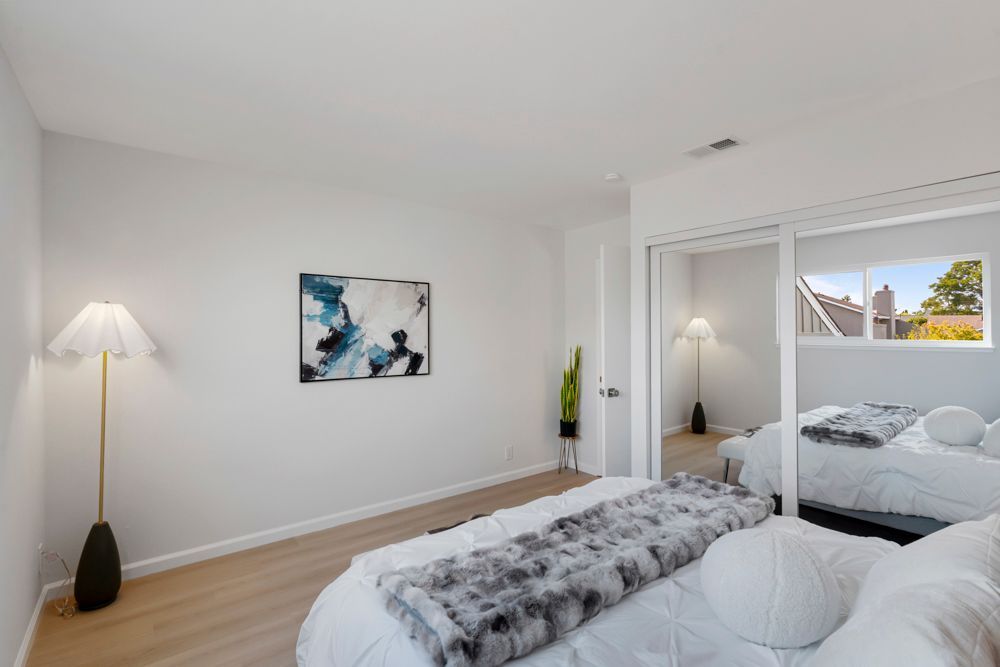 Secondary bedroom with mirrored closet and leafy outlooks, located in Foster City’s desirable Harborside townhome community, listed with Rumana Jabeen Realtor.