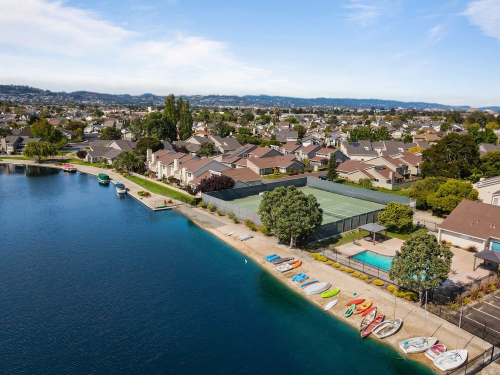 Resort-style Harborside amenities including pool, tennis courts, and sandy beach, listed by Foster City Realtor Rumana Jabeen.