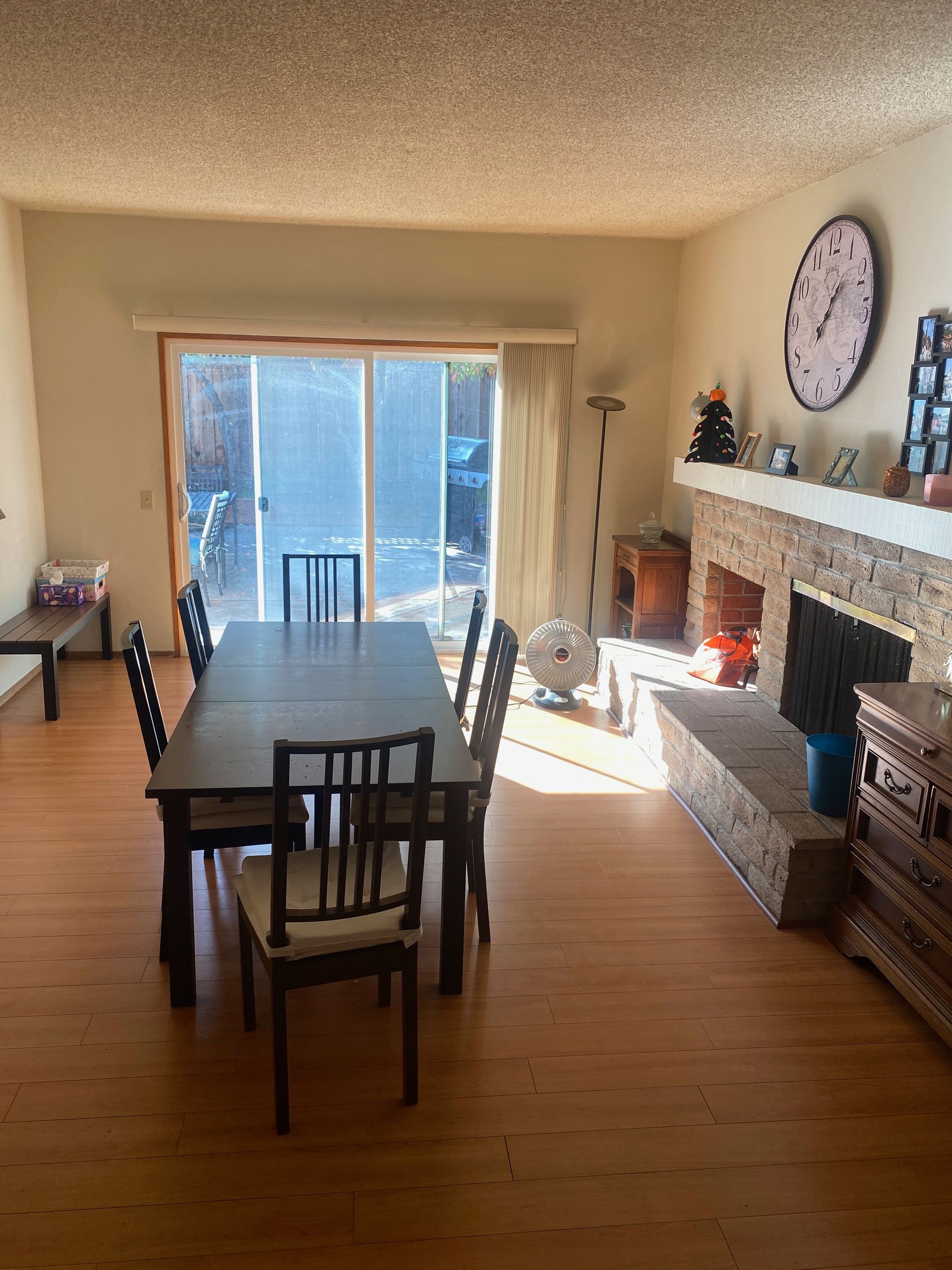 A living room with white furniture and a large window.