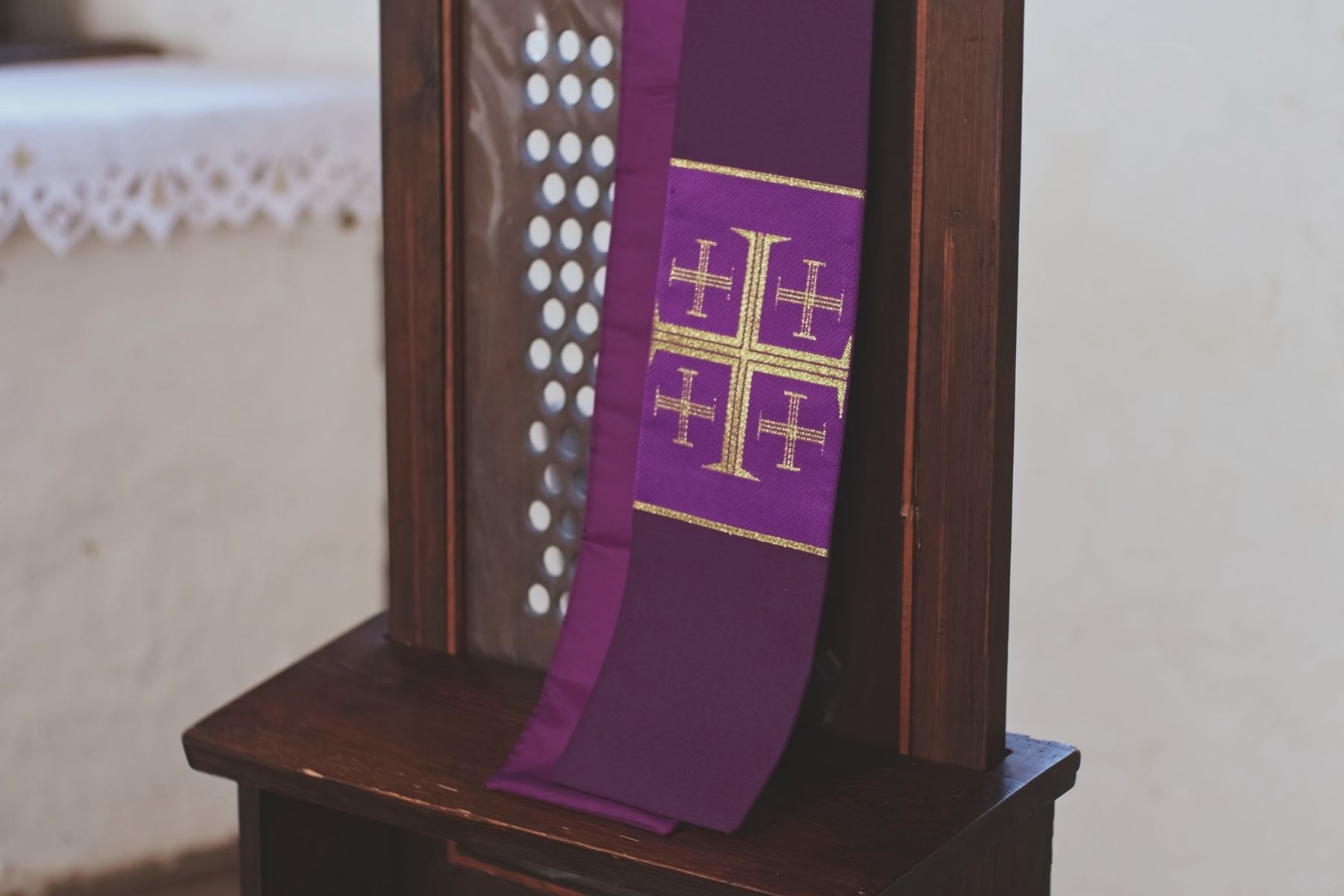 Jesus appearing in a church, blessing two children kneeling at confession. A priest hears confession.