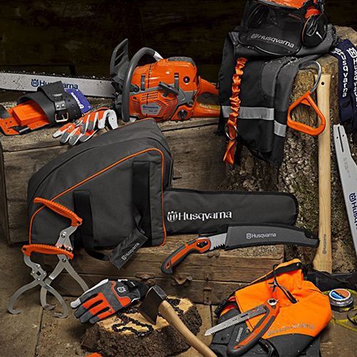 A husqvarna chainsaw is sitting on top of a wooden box.