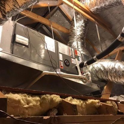 An air conditioner is hanging from the ceiling of a building