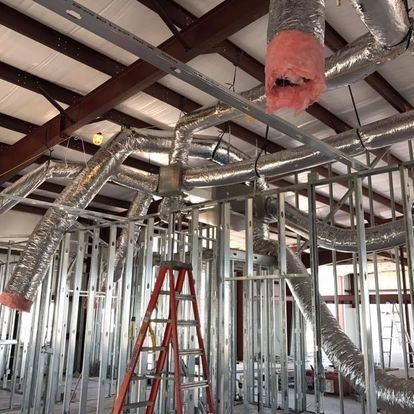 A ladder is in the middle of a building under construction