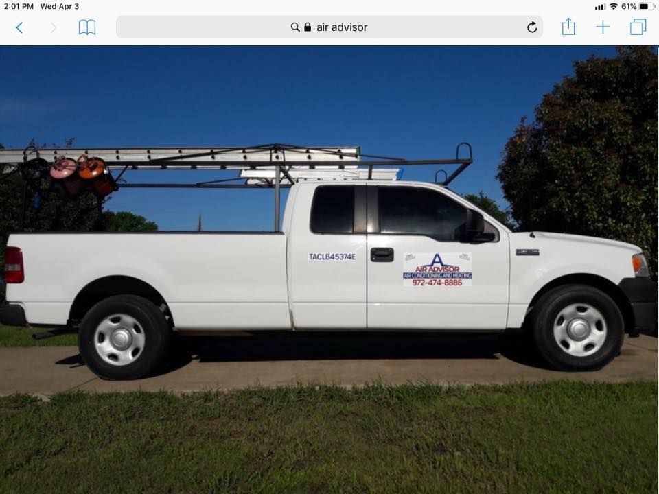 A white truck with a ladder rack on top of it