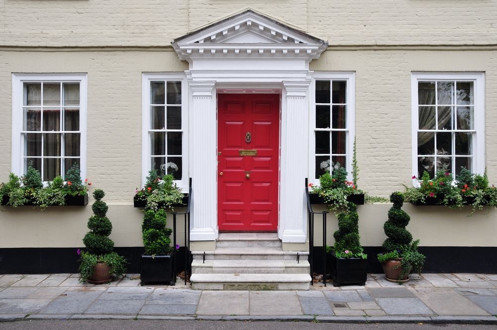 A house with a red door and white windows