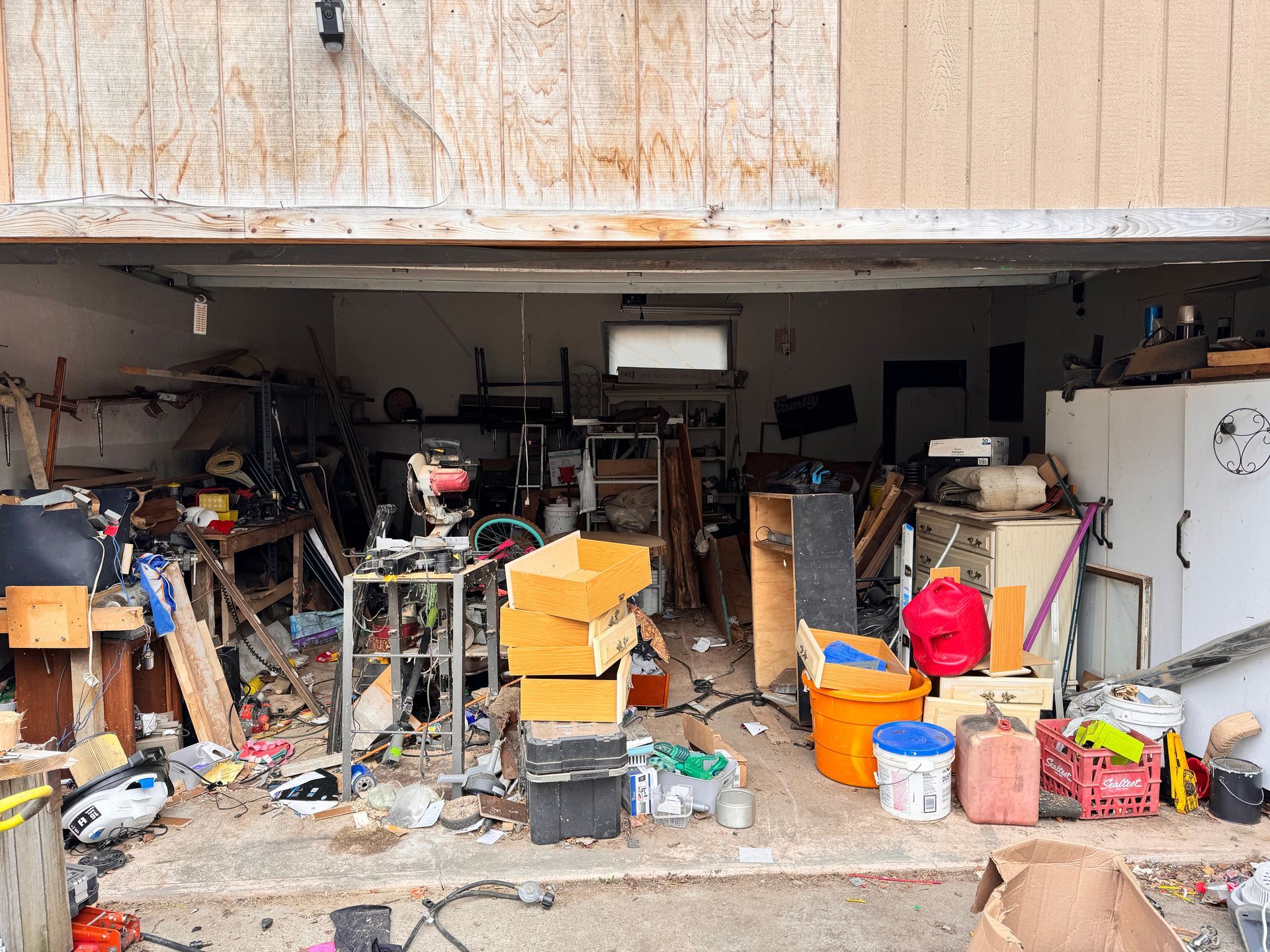 A garage filled with lots of junk and tools.