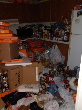 A messy kitchen with boxes and bags including one that says fragile