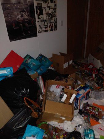 A room filled with lots of boxes and trash bags