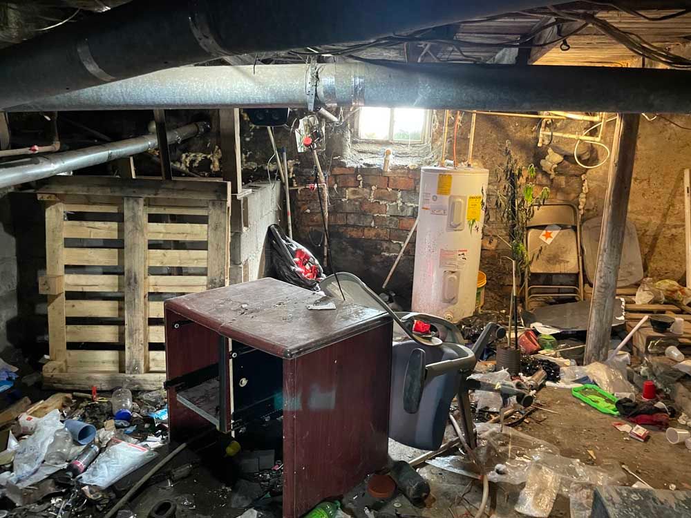 A basement filled with lots of trash and junk.