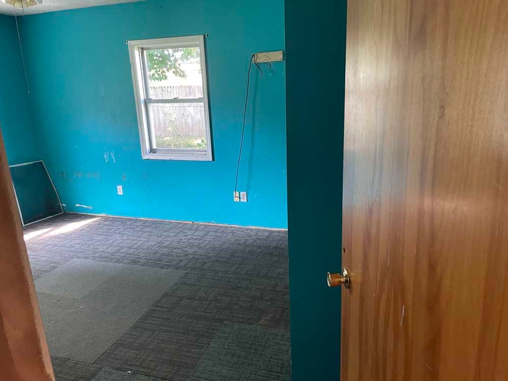 A room with blue walls and a wooden door.