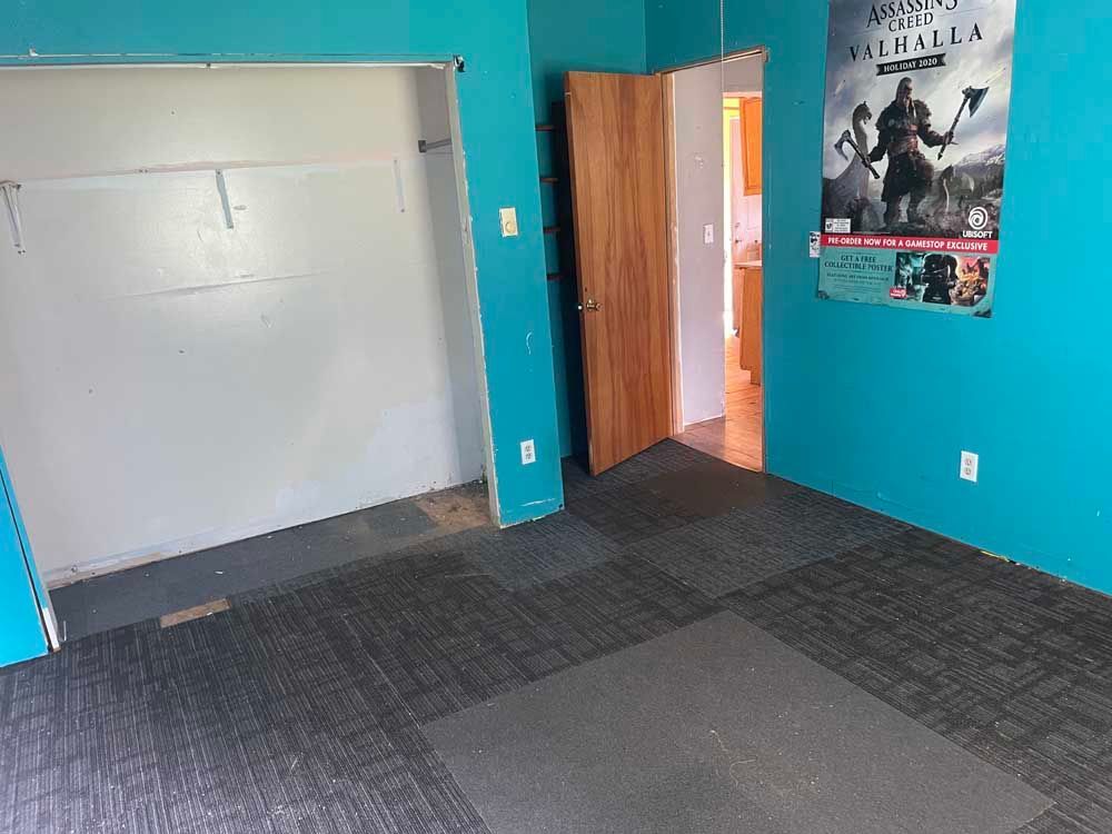 A room with blue walls and a poster on the wall.