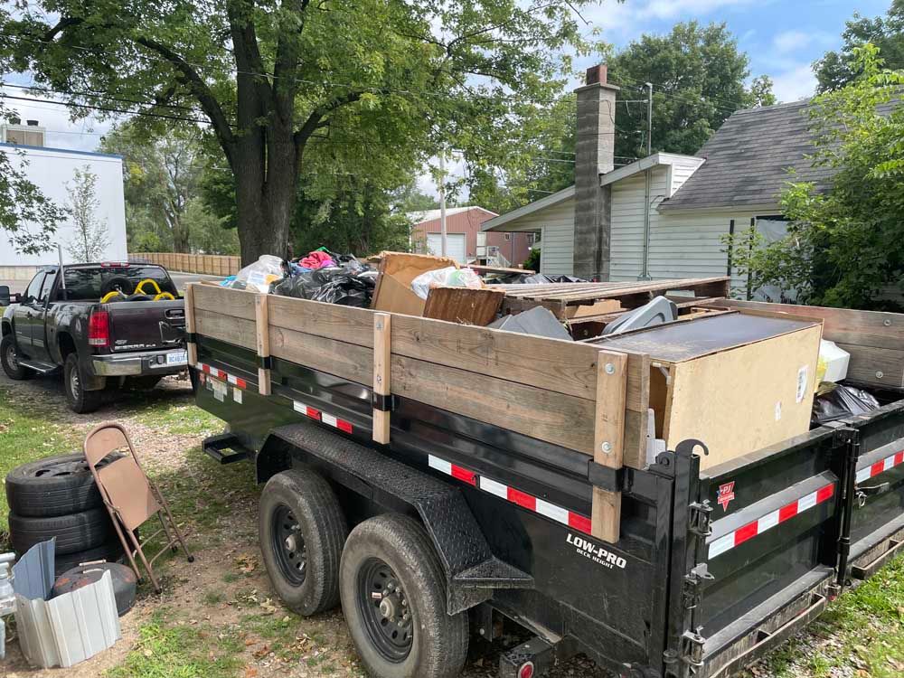 Utility Trailer Black loaded with trash