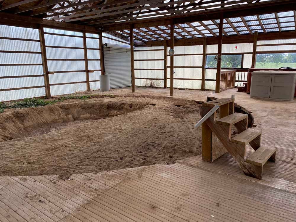 There is a large hole in the ground in the middle of the room.