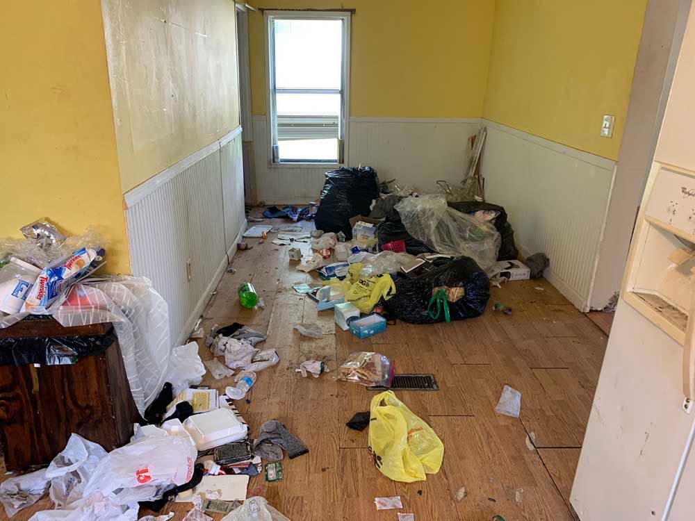 A room with a lot of trash on the floor.