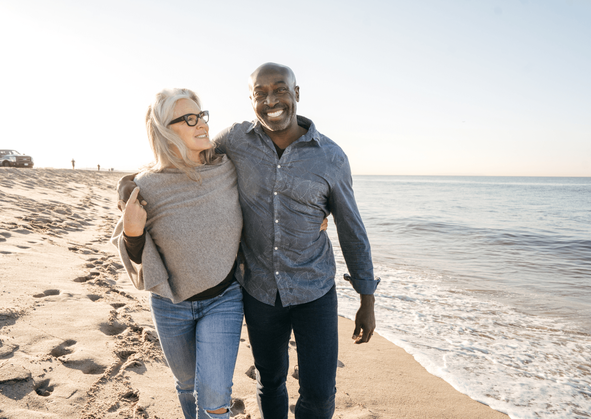 senior couple on medicare walking on beach