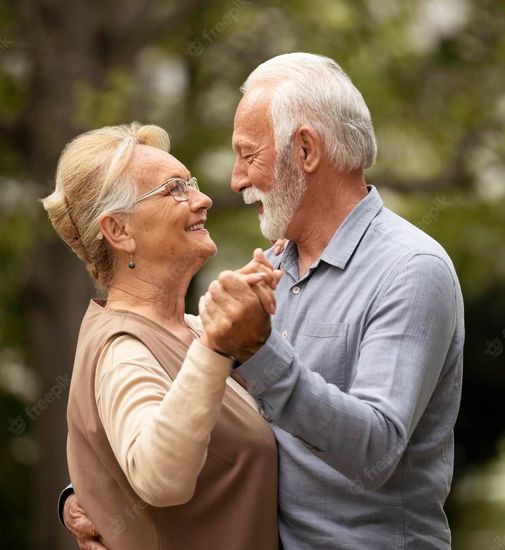 happy senior couple with Medicare Insurance dancing