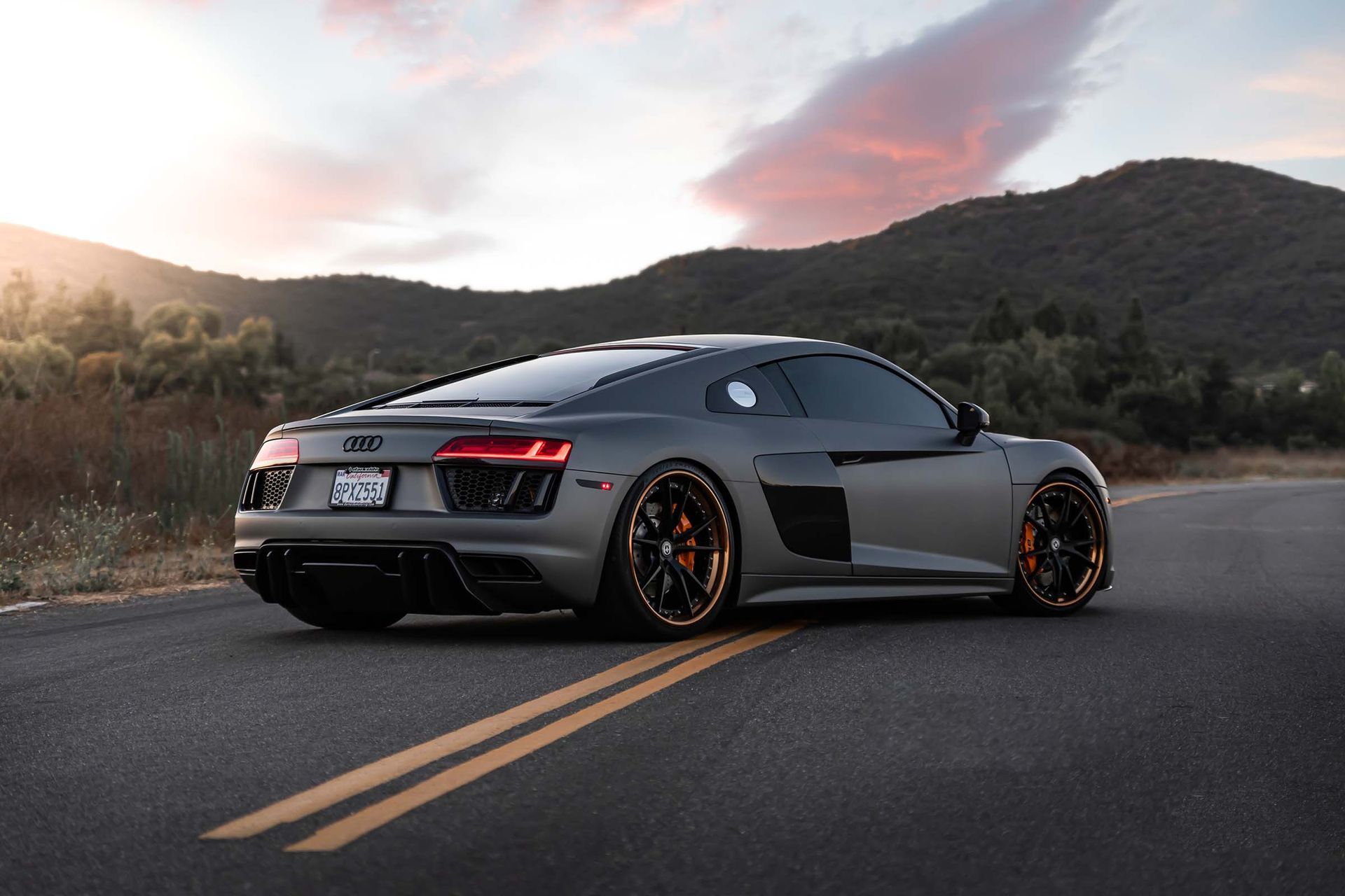 A person is cleaning the floor of a car with a vacuum cleaner.