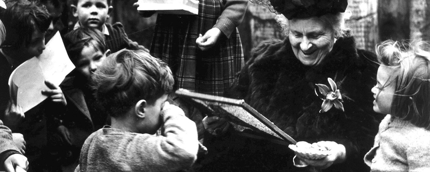 Dr. Maria Montessori surrounded by children