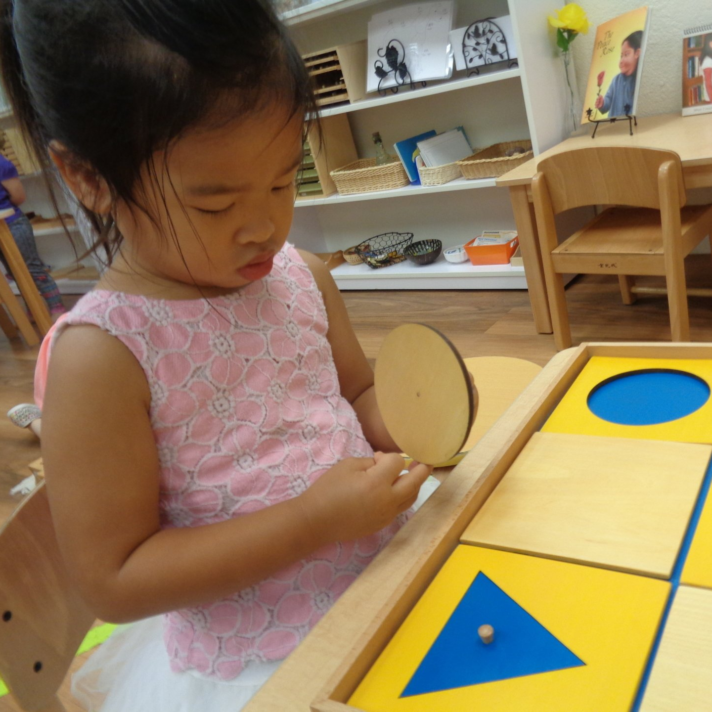 Child working with a Montessori puzzle