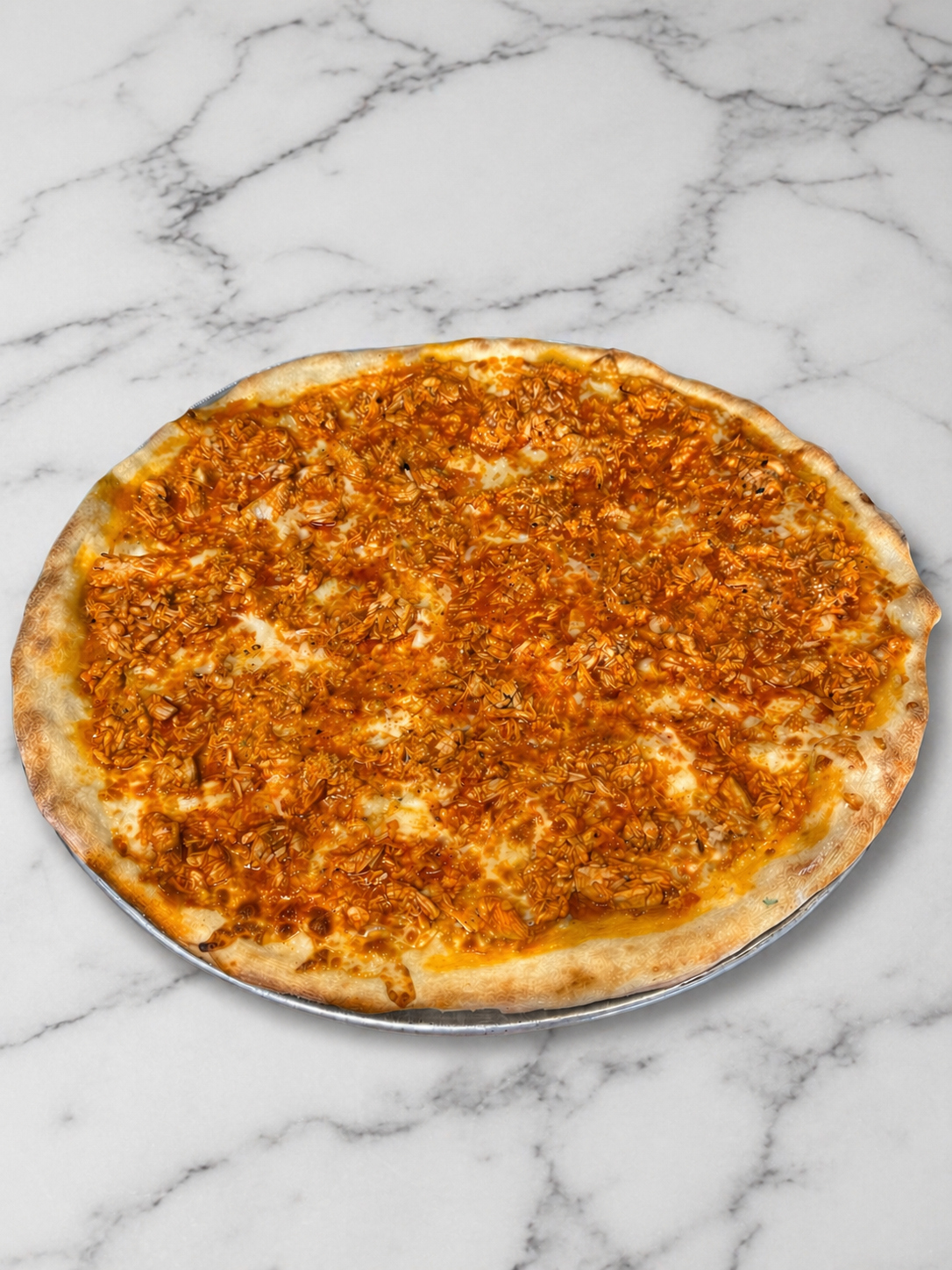 Cheese pizza on a marble countertop, viewed from above
