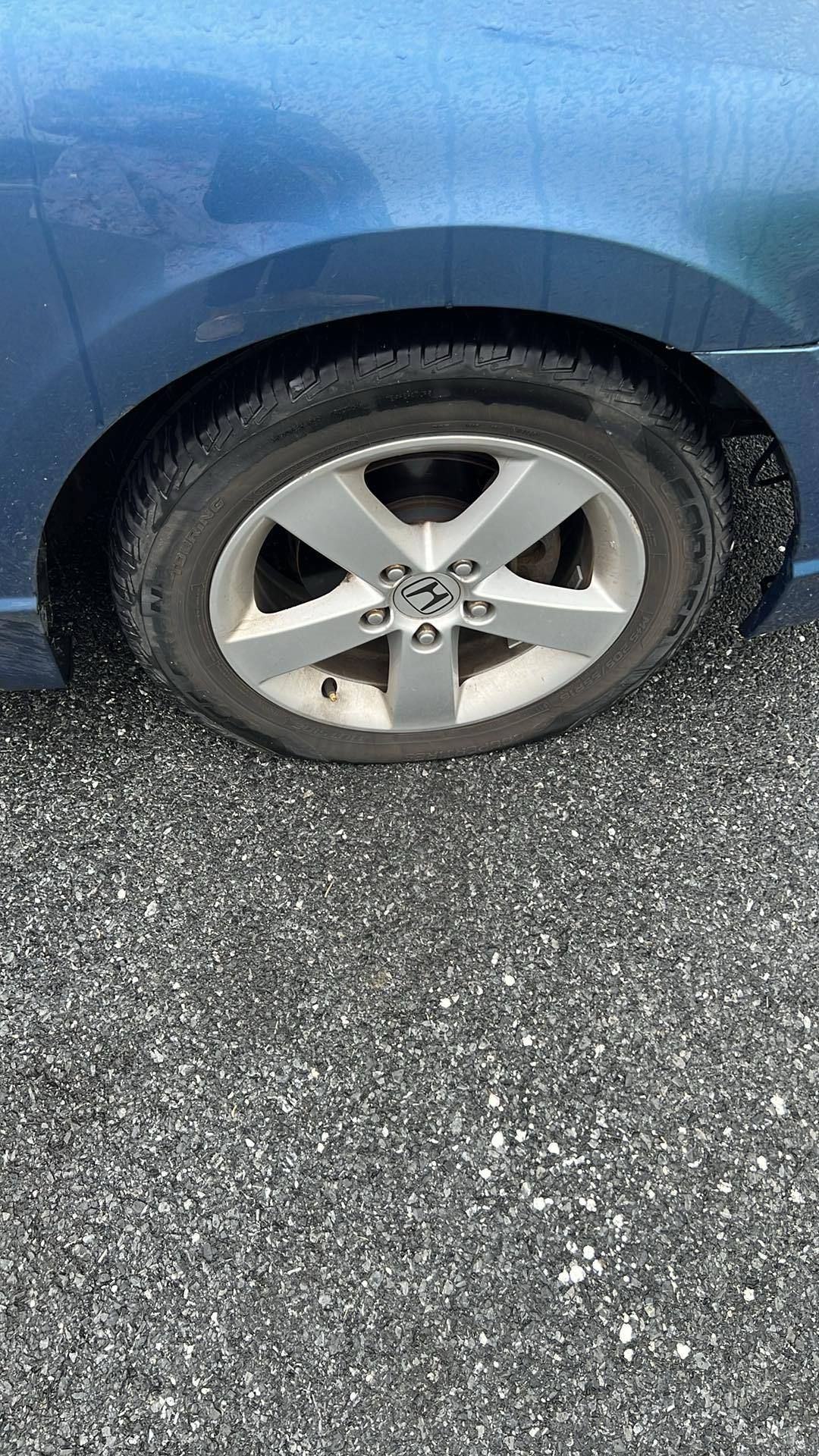 Blue car wheel and tire on asphalt | Central Auto Works