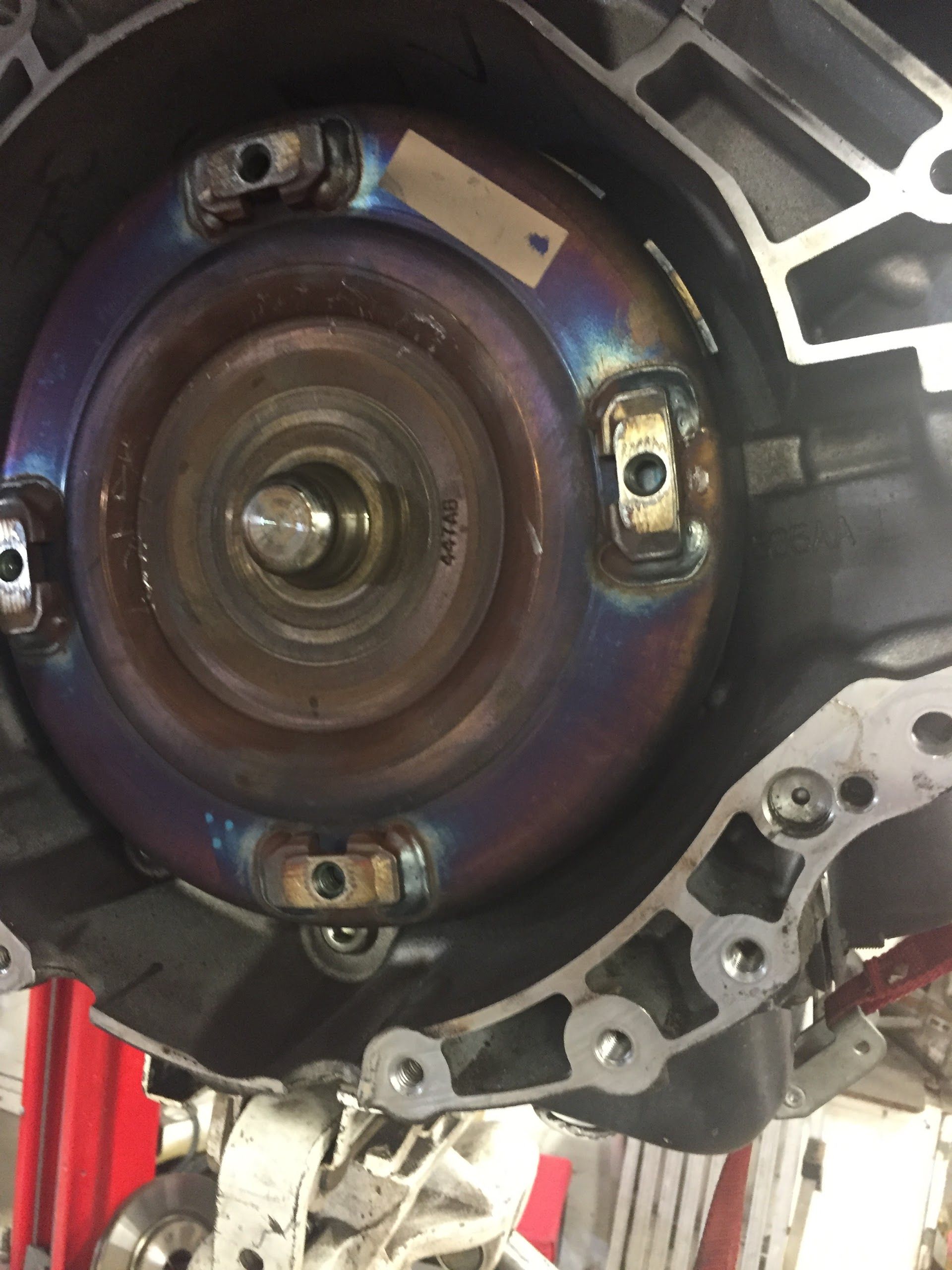 Torque converter inside a transmission housing, showing heat discoloration | Central Auto Works