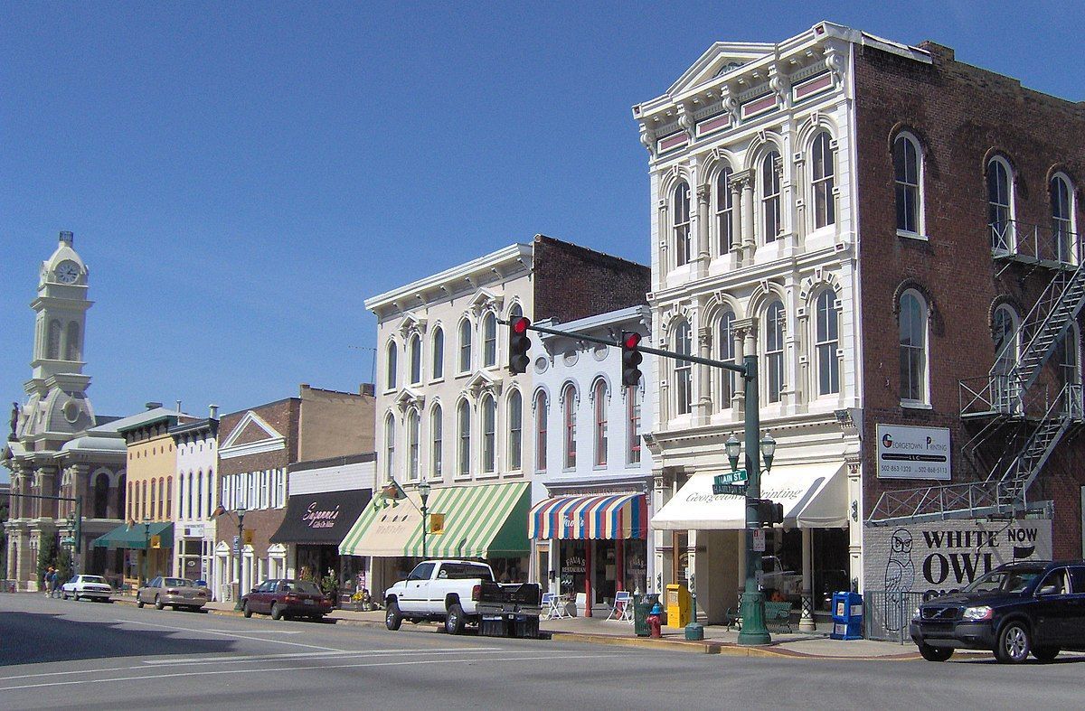 A row of buildings with one that says ' white owl ' on it