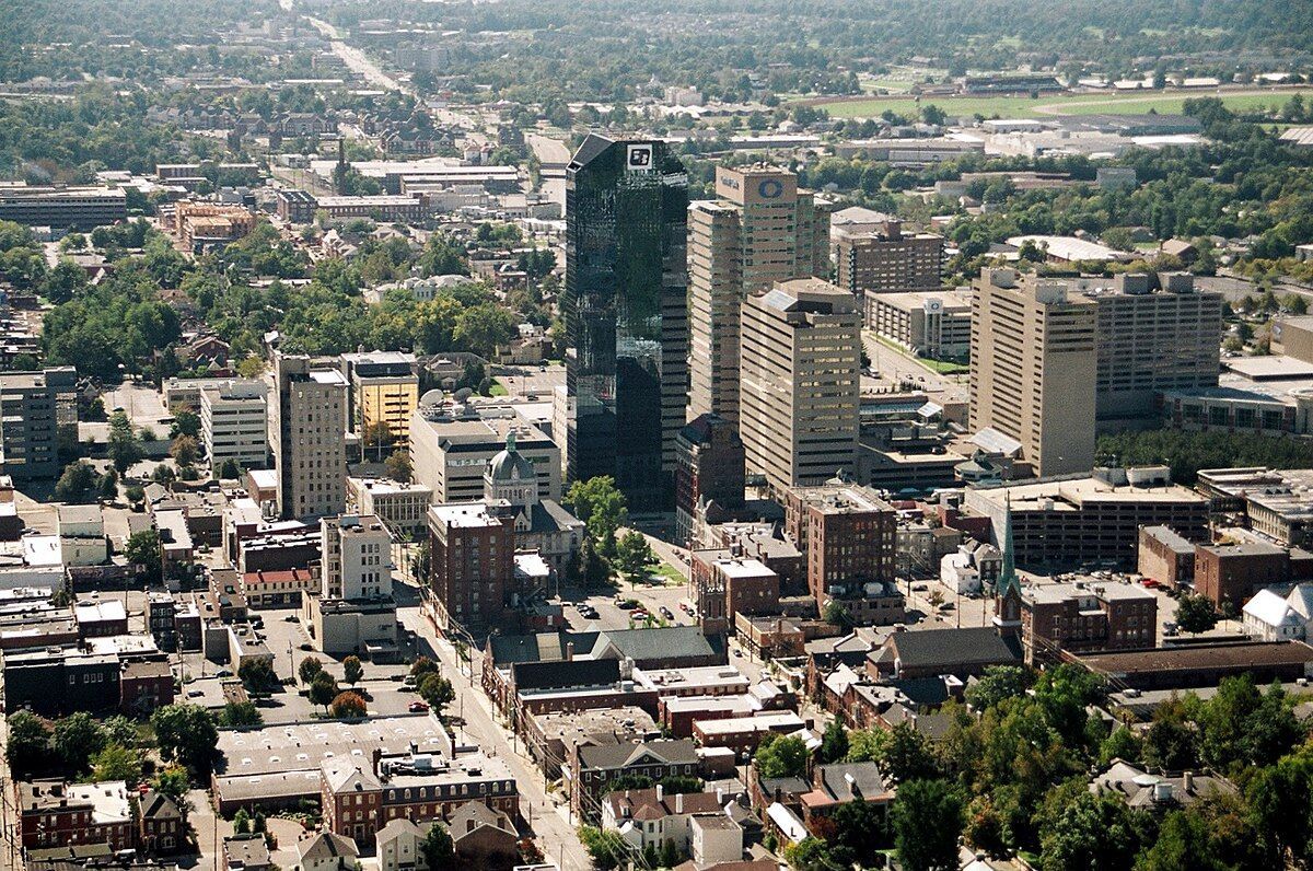 An aerial view of a city with lots of buildings and trees