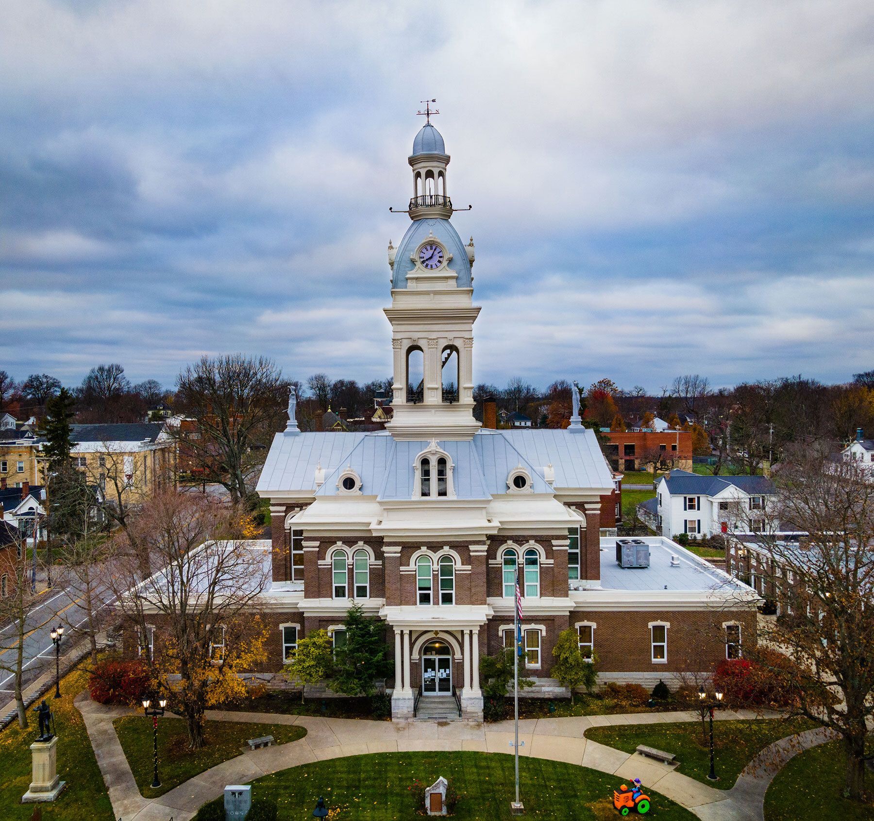 An aerial view of a large brick building with a clock tower