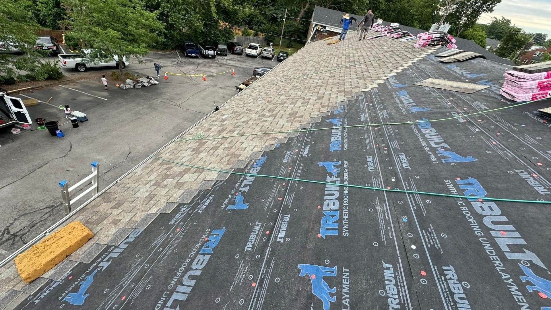 A man installing a shingle roof.